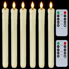 five lit candles with remote controls in front of them