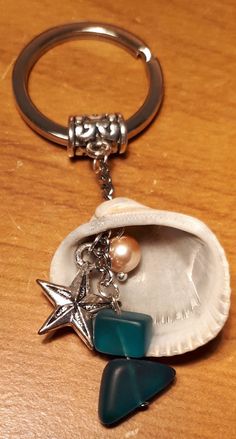 a keychain with a starfish and seashell on it