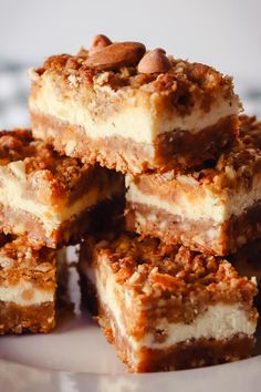 several pieces of cake sitting on top of a white plate with pecans in the middle