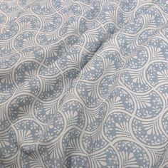 a blue and white fabric with an intricate design on it's side, in the middle