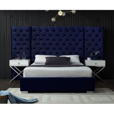 a bedroom with a blue headboard and white bed in the middle, surrounded by black walls