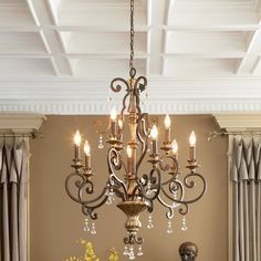 a chandelier hanging from the ceiling in a dining room