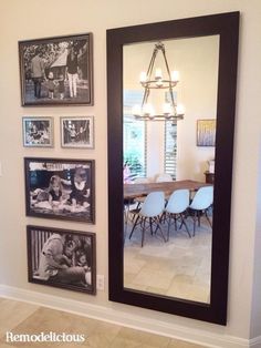 a large mirror mounted to the side of a wall next to a dining room table