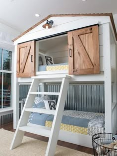 a white bunk bed with wooden shutters and ladder