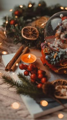 a table topped with candles and christmas decorations