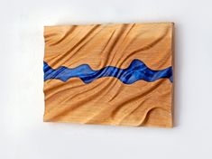 a piece of wood with blue waves painted on it