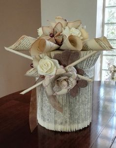 a vase filled with flowers on top of a wooden table