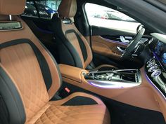 the interior of a car with tan leather and black trim