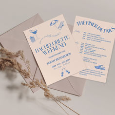 two wedding cards with blue ink on them and some dried grass in front of them