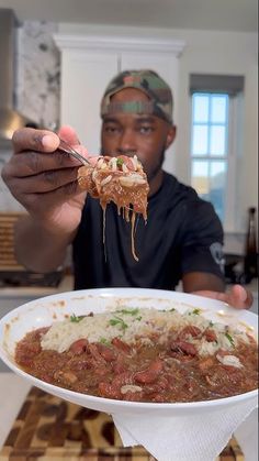 a man eating food from a white bowl