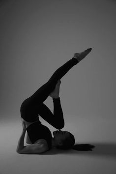 a woman is doing a handstand on the floor