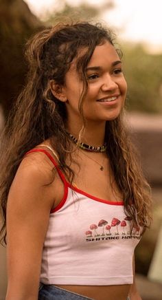 a woman with long hair wearing a crop top