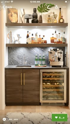 a kitchen with shelves filled with bottles and glasses on top of the counter, next to a rug