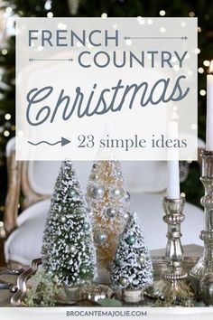 a table topped with christmas trees and candles next to a sign that says french country christmas