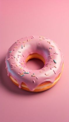 a donut with pink icing and sprinkles on a pink background