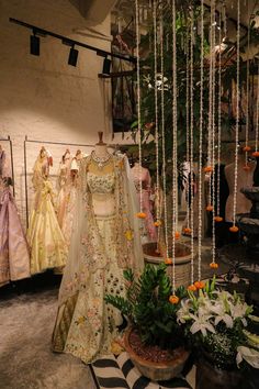 dresses and flowers are on display in a store