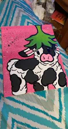 a painting of a black and white cow with a green mohawk on it's head