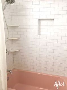 a pink bath tub sitting in a bathroom next to a white shower curtain and tiled walls