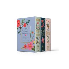 three books with floral designs on them, one in blue and the other in pink