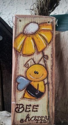 a wooden sign with a bee holding an umbrella