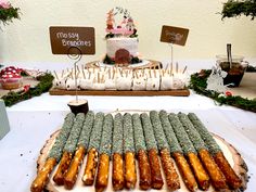 a table topped with lots of different types of breads and buns covered in frosting