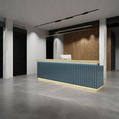 an empty room with a blue counter and black shutters on the wall behind it