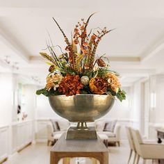 a large metal bowl filled with lots of flowers