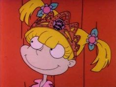 a cartoon character wearing a tiara and smiling