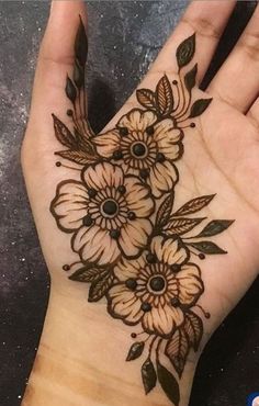 a woman's hand with flowers on it