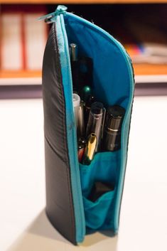 an open zippered pouch filled with cosmetics