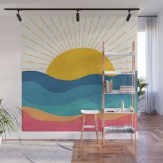 the sun is shining brightly over the ocean wall mural in this living room with wood flooring