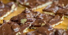 pieces of chocolate and nuts on a cutting board