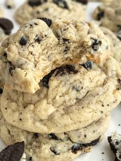 chocolate chip cookies stacked on top of each other with one cookie broken in the middle