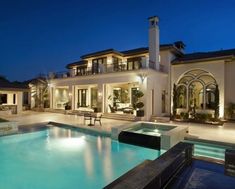 a large house with a swimming pool at night