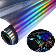 a close up of a rainbow colored foil on a roll of paper with the image of an eagle's head