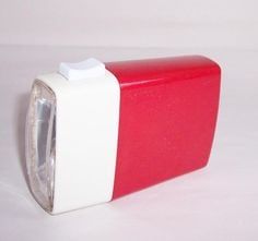 a red and white object on a white surface with no one in the photo to describe it