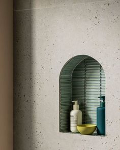 a bathroom with a sink, mirror and soap dispenser on the wall