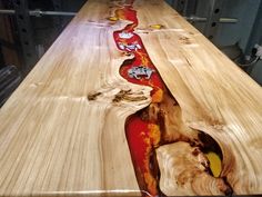 a long wooden table with red and yellow designs on it