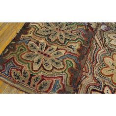 two rugs on the floor with different colors and patterns, one is multicolored