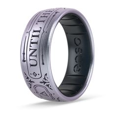 a ring with an intricate design on the inside, and black rubber inlays