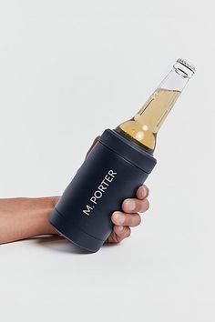 a person holding a bottle in their hand with the word moloter on it