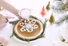 a person is decorating a pie with icing