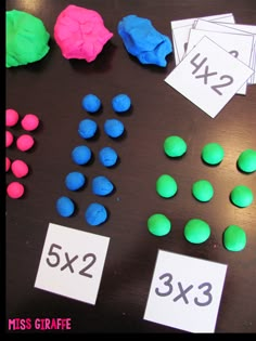 the table is covered with different colored candies and numbers for each individual to use