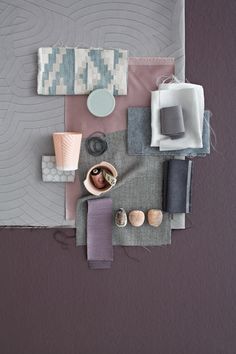 an overhead view of various items on a table with purple and grey wallpaper in the background