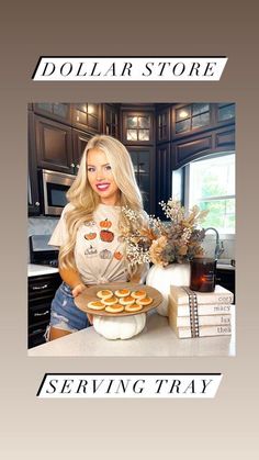 a woman holding a plate with donuts on it in front of a kitchen counter