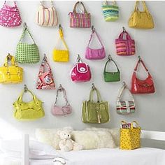 Good Life of Design: What a fun, colorful, pretty way to display your purses, on hooks! Dorm Room Space Savers, Hanging Purses, Purse Display, Handbag Display, Purse Storage, Handbag Storage, Purse Hook, Bag Display, Handbag Organization