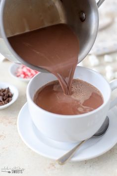 chocolate being poured into a white cup