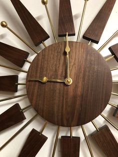 a clock made out of wood and brass sticks