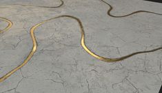 a yellow snake is on the ground with some gold lines in it's mouth