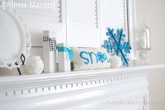 a fireplace mantel with snow decorations on it